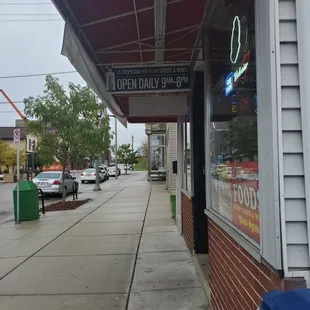a view of a sidewalk in a small town