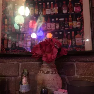a vase of flowers and bottles of beer