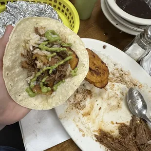 Ropa Vieja: Shredded beef, White Rice, Black Beans, Sweet Plantains, tortillas &amp; salsas