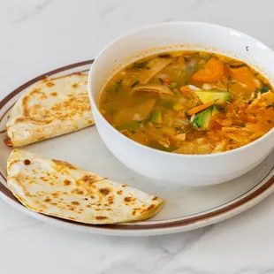 Lunch chicken soup with two cheese quesadillas.