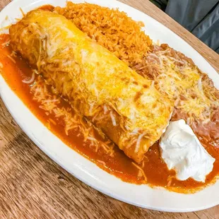 Enchilada style steak burrito with rice and beans