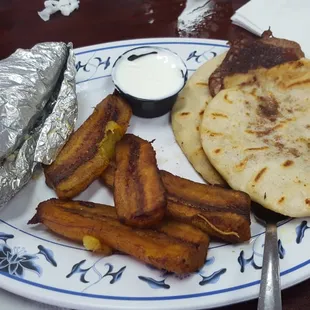 Combination B. 2 pupusas (frijoles and queso). Fried plantains. And a tamale. Pupusas were good. Plantains were half good. Tamale was good