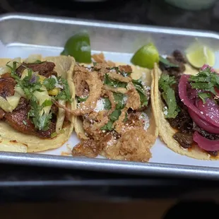 three tacos on a tray