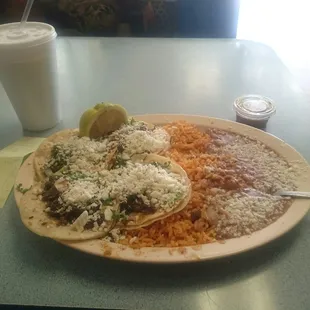Carne Asada tacos with beans and rice. It feels so natural Lol Home Sweet Home.....