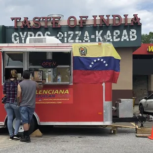 a man standing in front of a food truck