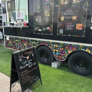 a food truck with a menu on the side
