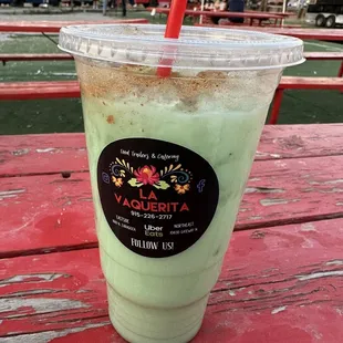 a drink on a red picnic table