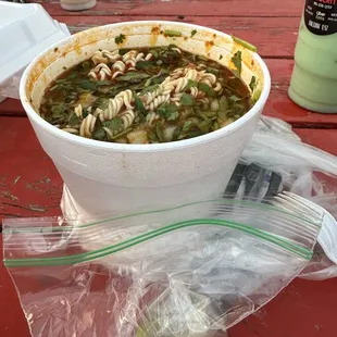 a bowl of soup on a picnic table