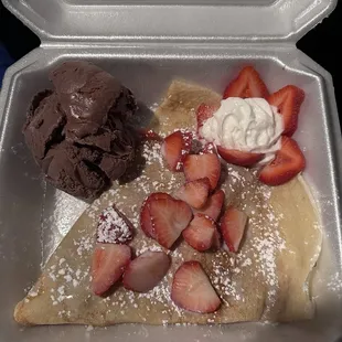 Crepe with peanut butter filling, strawberries, and chocolate ice cream