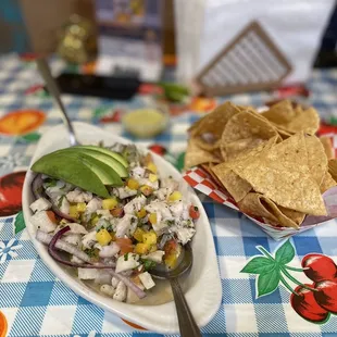 a plate of chips and a bowl of salsa