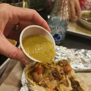 Vegan rice and bean burrito with pico de gallo and green salsa.