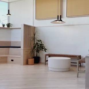 a white room with a wooden table and a bench