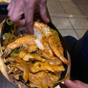 a person holding a bowl of food