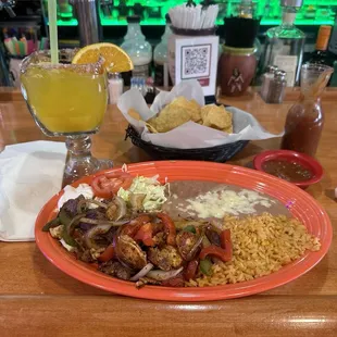 Steak and chicken fajitas for lunch and a mango margarita.