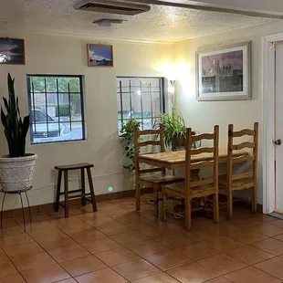 a view of a dining room with a table and chairs