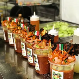 a row of bloody cups with different toppings