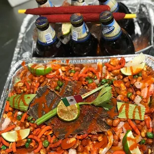 a tray of food and bottles of beer