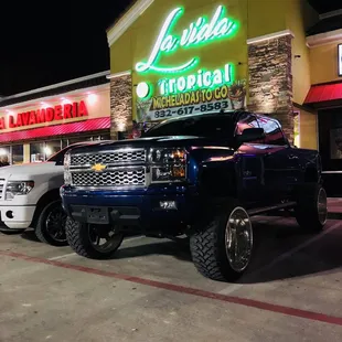 a truck parked in front of a restaurant