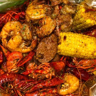 a plate of crawfish and corn