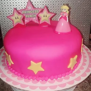 a pink cake with stars on top