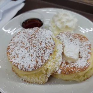 two pancakes with powdered sugar
