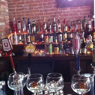 a row of empty wine glasses on a bar