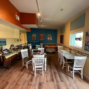 a dining area with tables and chairs