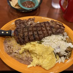 Green Chili Chilaquiles, scrambled eggs &amp;  Steak