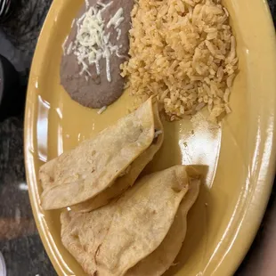 2 chicken tacos no lettuce with rice and beans