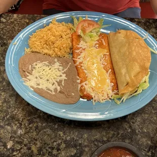 Cheese enchilada and chicken taco with rice and beans