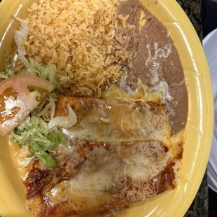 Chicken and cheese enchilada plate with beans and rice