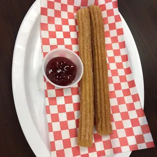 Churro de Canela (fried dough rolled in sugar and cinnamon with a side of strawberry jam) $2.50