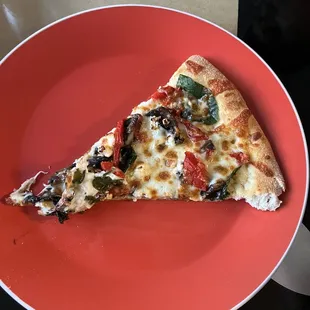 a slice of pizza on a red plate