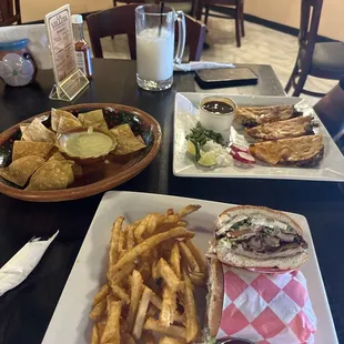 A torta, tacos de birria and chips