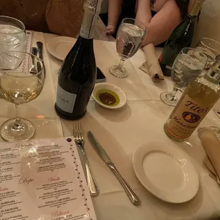 a table with a bottle of wine and glasses