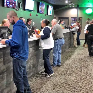 a line of people at a bar