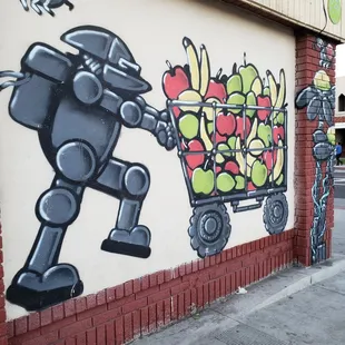 a robot pushing a cart of fruit