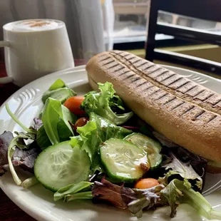 Chicken Pesto Aioli Panini w side salad - tender grilled chicken breast with provolone cheese, creamy pesto aioli, and fresh tomato, avocado