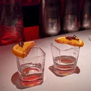 Like a tequila shot but grasshopper = salt, mezcal = tequila, and orange = lime. Traditional way of drinking mezcal in Mexico.