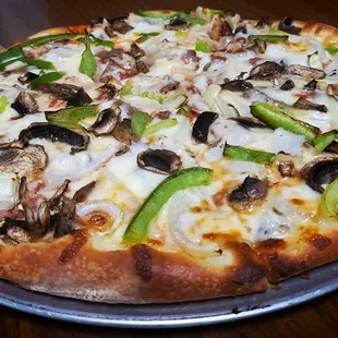 a pizza with mushrooms and peppers
