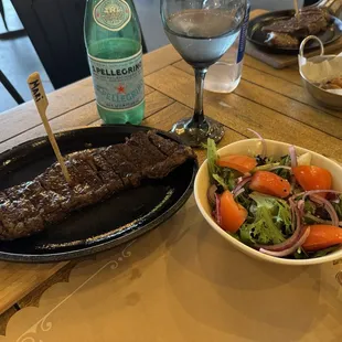 Wagyu Denver Steak with salad. The one in the back with potatoes.