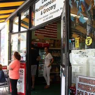 a woman standing in the doorway of a store