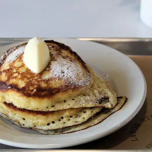 a stack of pancakes with butter on top