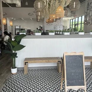 a chalkboard sign in front of the counter