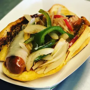 a hot dog with onions and peppers