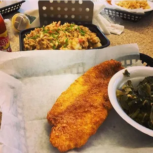a fish fillet with a side of greens