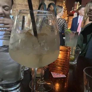 a woman sitting at a bar with a drink