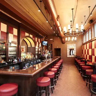 a bar with red stools
