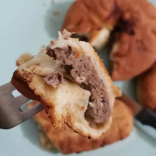 a bite of a sausage sandwich