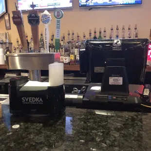 a bar with a television and a counter